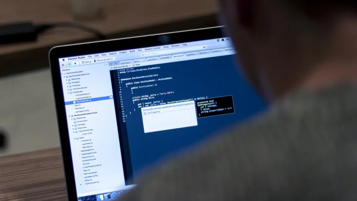 Technology professional analyzing artificial intelligence data on screen
