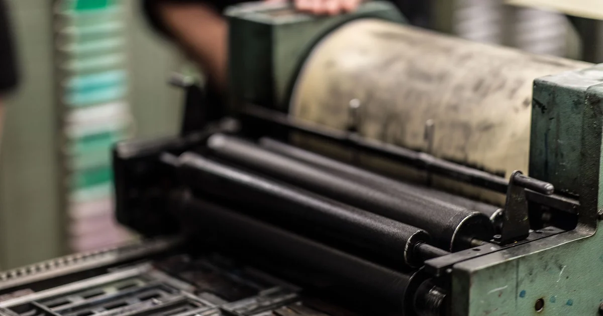 Printing press with rollers and cylinder in a print shop