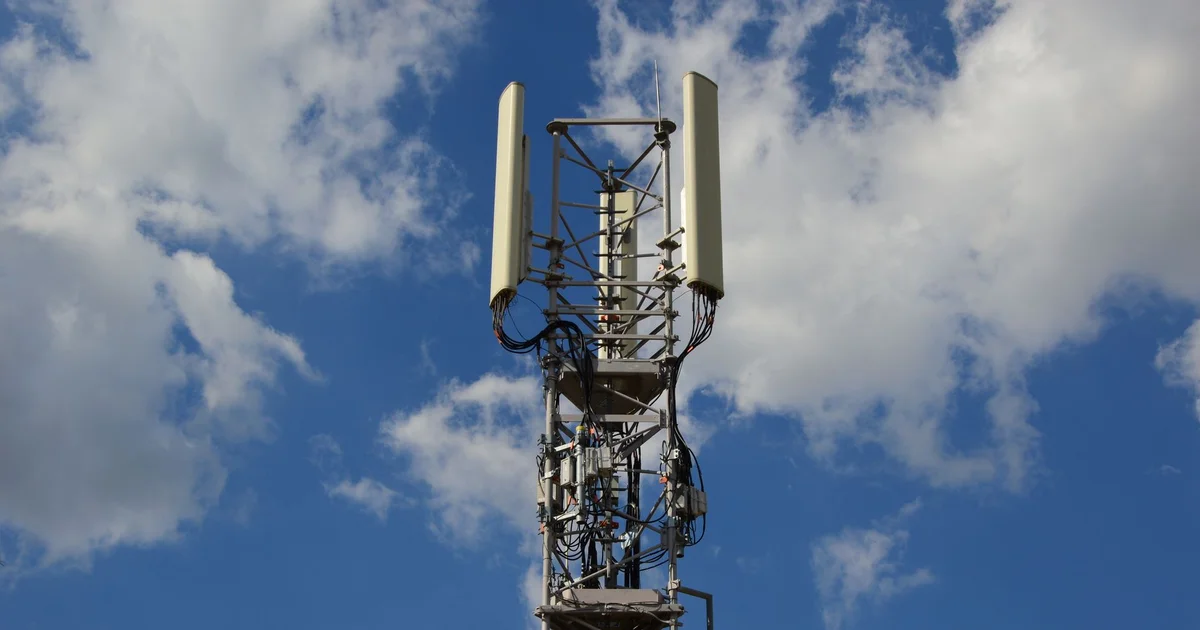 Technician inspecting a private 5G antenna inside an industrial plant